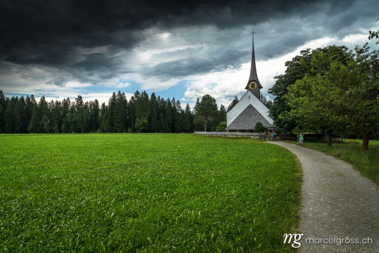 . Thunderstorm atmosphere over the Wützbrunnen church in Röthenbach in the Emmental. Marcel Gross Photography