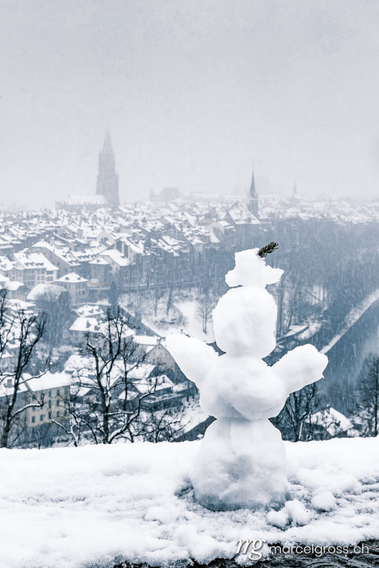 Bern pictures. Snowman in front of the old town of Bern, Bern. Marcel Gross Photography