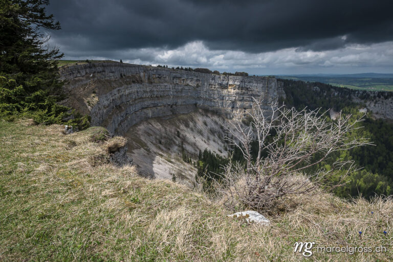 . spectacular view from Creux du Van with dark clouds. Marcel Gross Photography