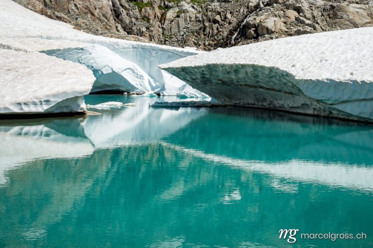 . melting snow in alpine lake. Marcel Gross Photography