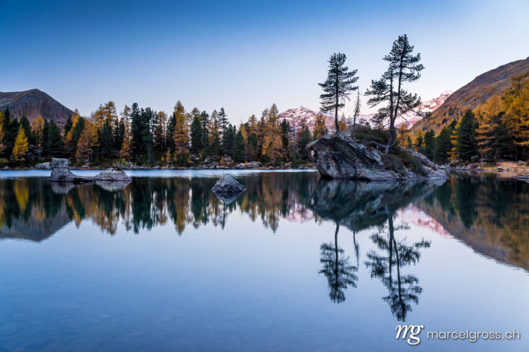 . Sunrise at an alpine lake with reflection in autumn. Marcel Gross Photography