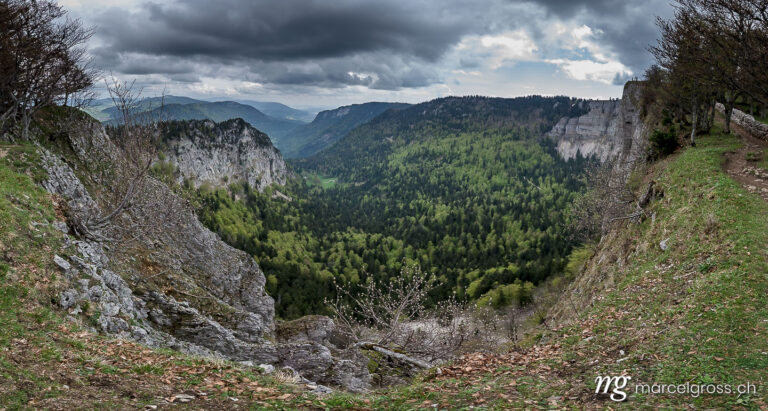 . spectacular view from Creux du Van with dark clouds. Marcel Gross Photography