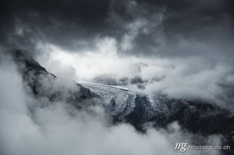 . moody and dark scenery on Aletsch Glacier on a cloudy and rainy day. Marcel Gross Photography