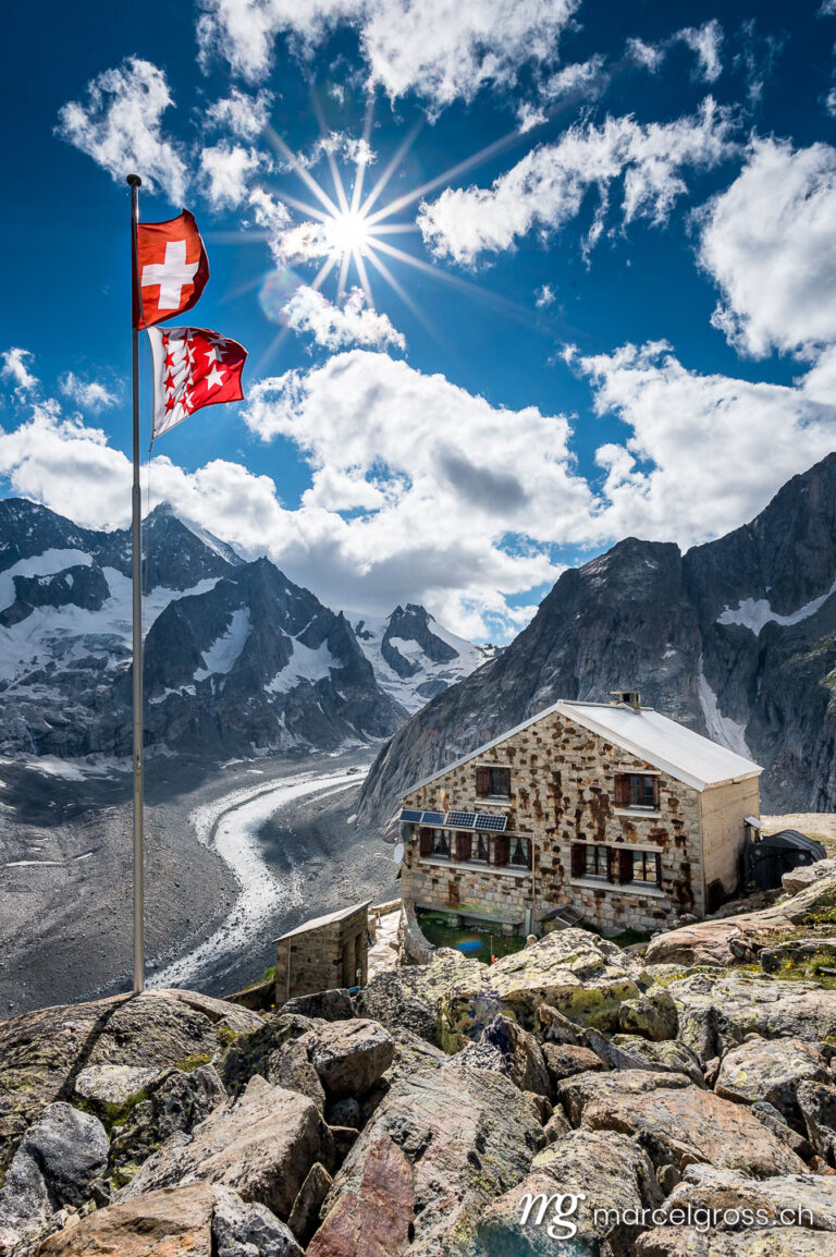 . oberaletsch Mountain hut with Oberaletsch Glacier and the Swiss and Valais Flag. Marcel Gross Photography