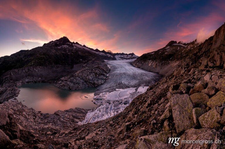 . dramatic colored clouds at sunset over Rhoneglacier. Marcel Gross Photography