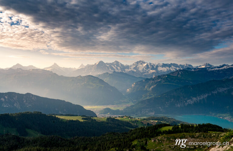 . View of Interlaken, Lauterbrunnen valley and Eiger, Mönch and Jungfrau with dramatic sunbeams. Marcel Gross Photography
