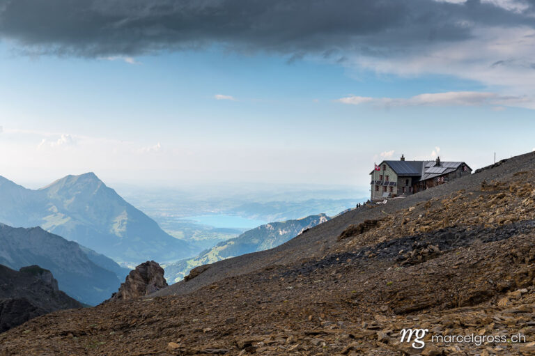 . Blüemlisalphütte SAC with Lake Thun and Thun in the distance in summer. Marcel Gross Photography