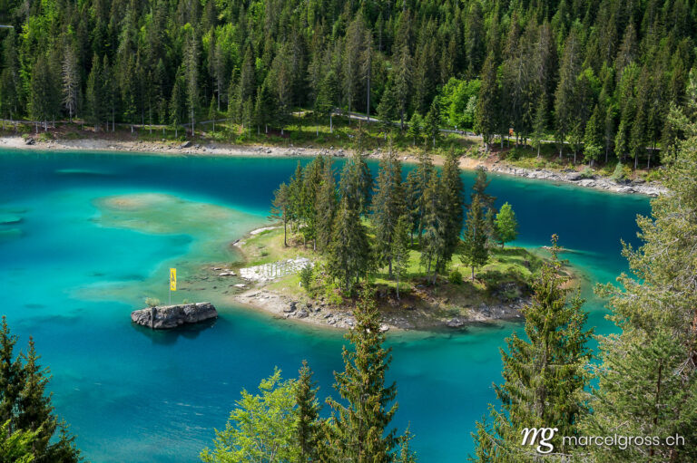 . clear, turquoise mountain lake with an island near Flims. Marcel Gross Photography