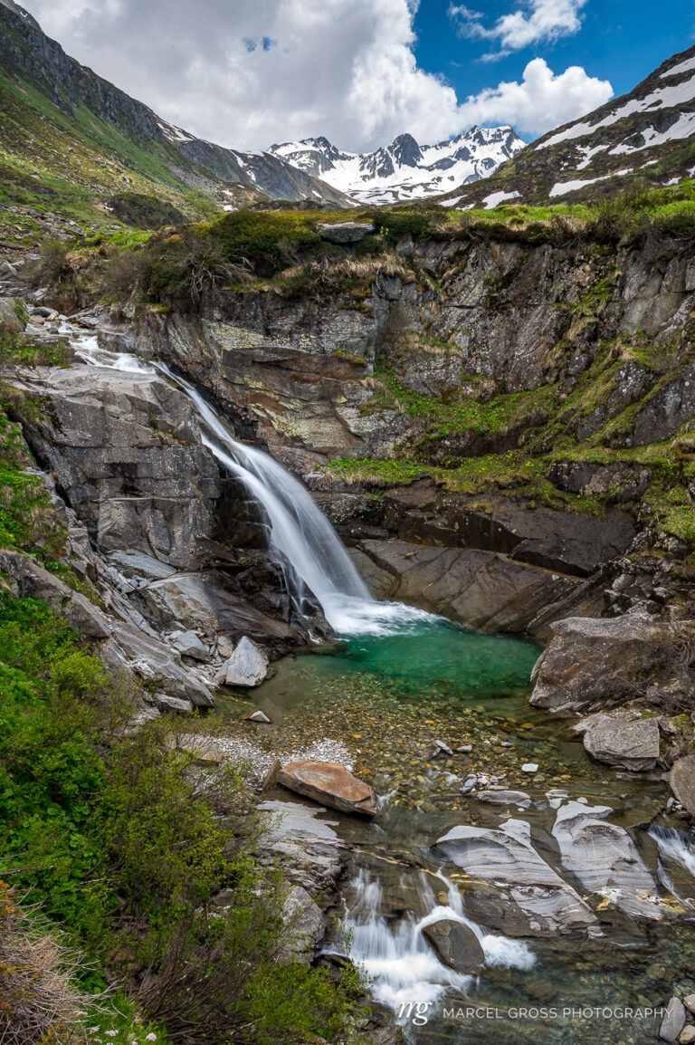 Long exposure of a small waterfall with a pool in the Unteralptal near Andermatt. Taken by Marcel Gross Photography