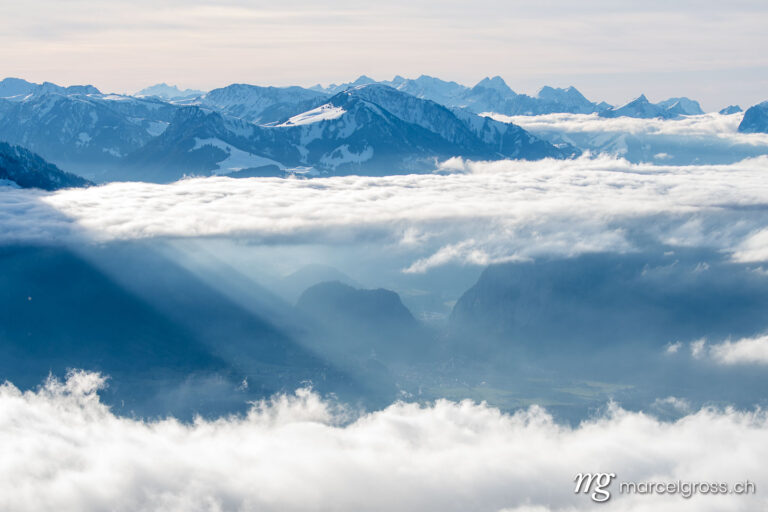 . sea of clouds with sunrays at the side of Mount Niesen and Simmental. Marcel Gross Photography