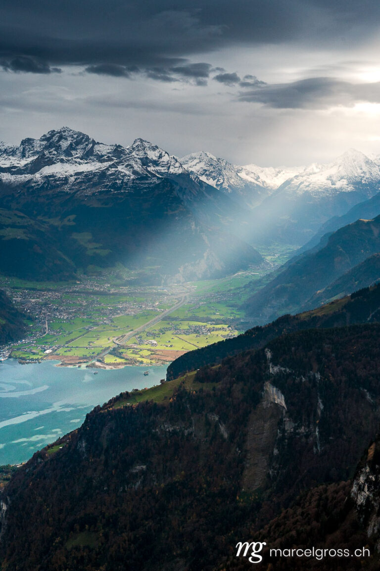 dramatic light into Reussebene with Altdorf and Urnersee. Taken by Marcel Gross Photography