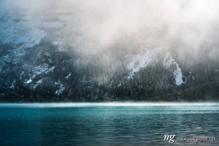 . mystic atmosphere on early winter with first snow at mountain lake Oeschinensee. Marcel Gross Photography