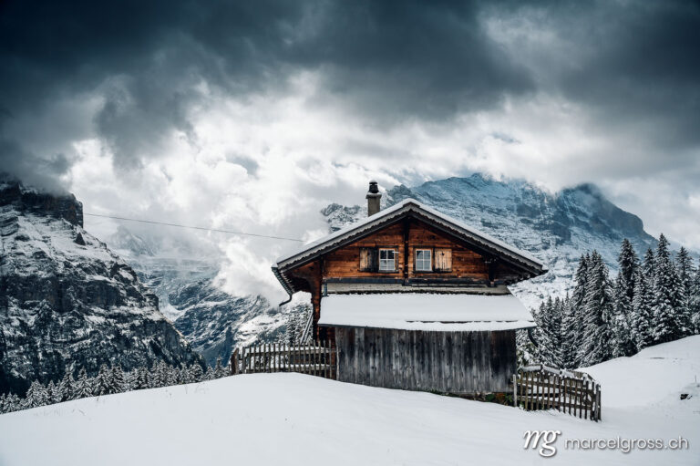 . wooden cottage in a winter fairytale landscape above Grindelwald. Marcel Gross Photography