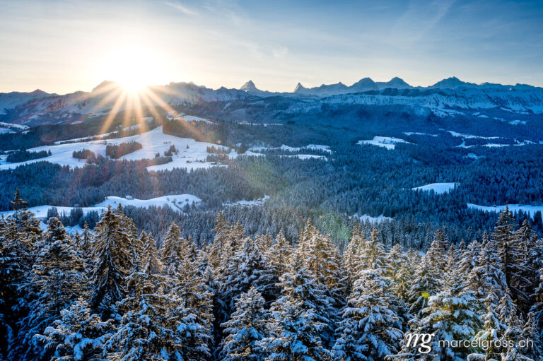 Winter picture Switzerland. sunrise over the hills of Emmental and Bernese Alps in winter. Marcel Gross Photography