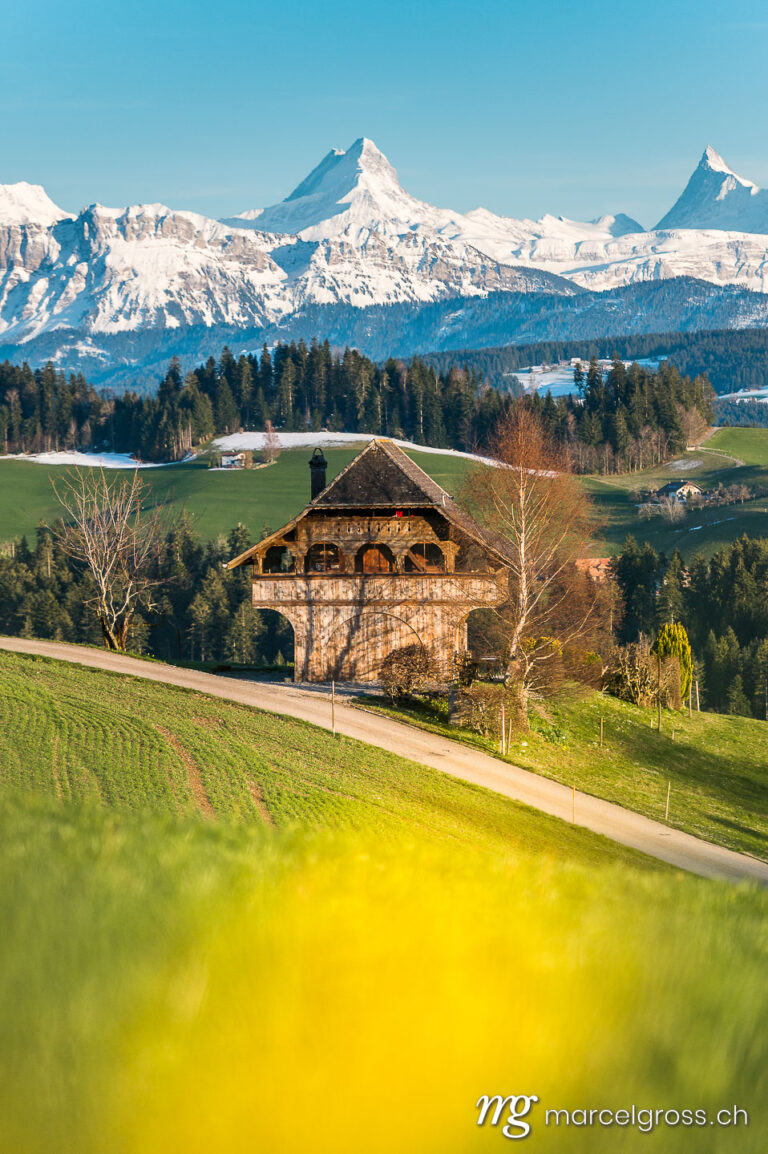 Emmental pictures. traditional Bernese farmhouse called Stöckli in front of the mighty Schreckhorn and Finsteraarhorn. Marcel Gross Photography
