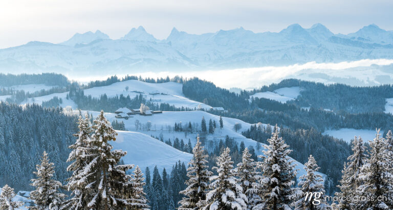 Winter picture Switzerland. remote traditional farm house in the hills of Emmental in winter. Marcel Gross Photography