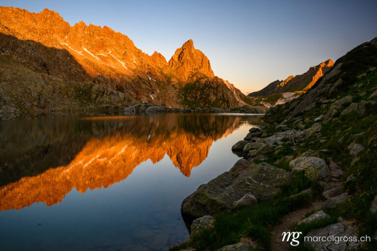. calm Lago di Lei and Pizzo Prèvat in the Ticino Alps at sunrise. Marcel Gross Photography