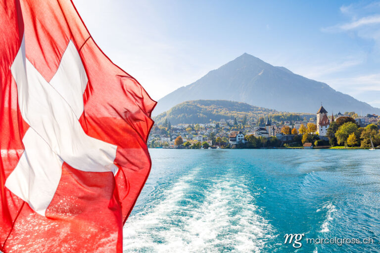 . swiss flag with Spiez and Niesen in the background. Marcel Gross Photography