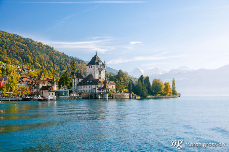 Autumn in Oberhofen. Oberhofen Castle with Eiger, Mönch and Jungfrau from Lake Thun in Bernese Oberland. Marcel Gross Photography