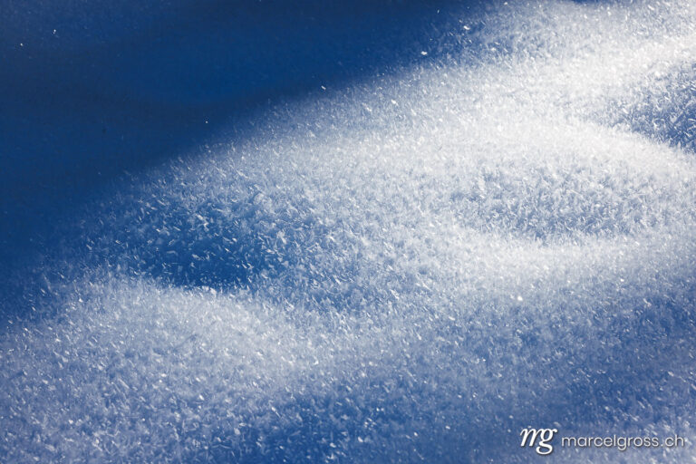. prestine white snow surface with ice cristalls for a background. Marcel Gross Photography