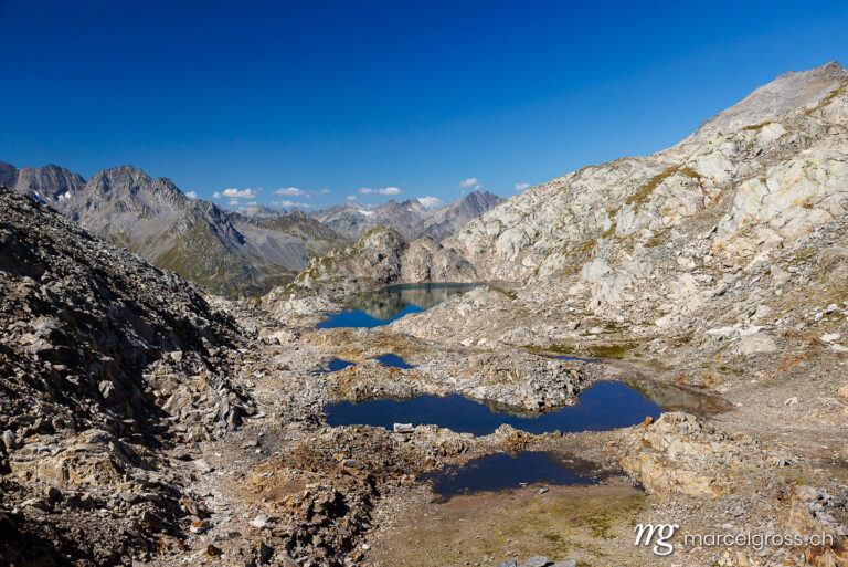Graubünden Bilder. Lai d'Uffiern lake seen from Pass d'Uffiern, Surselva. Marcel Gross Photography