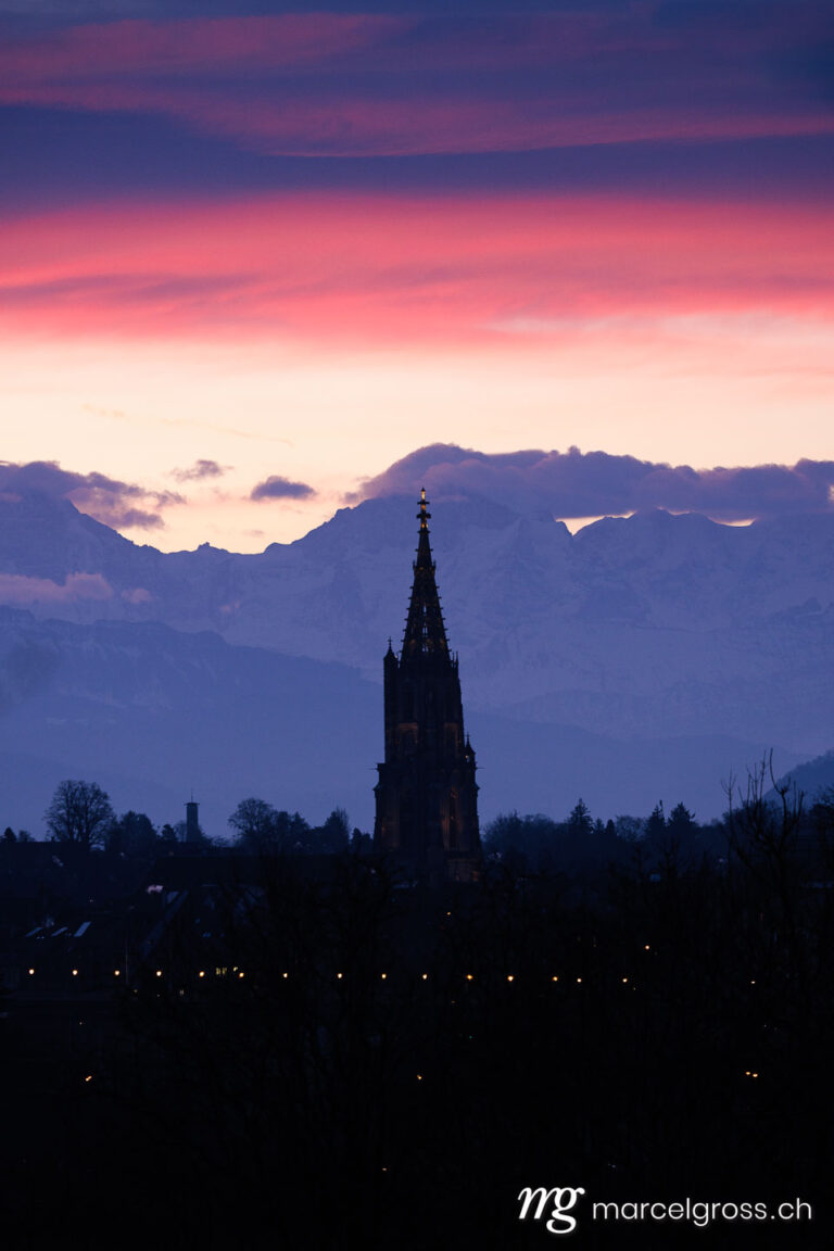 Bern pictures. Silhouette of the Bern Minster with Jungfrau during a sunrise. Marcel Gross Photography